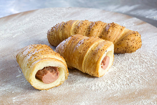 istock Sausage Rolls With Sesame Cut in Half on Wooden Board 501739986