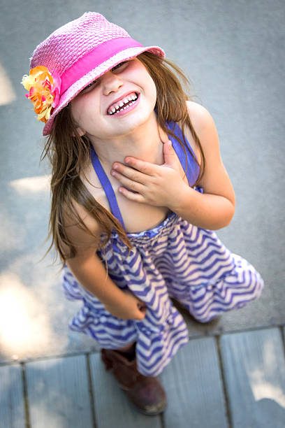 Adorable eight year old girl with long blond braid laughing on white background. Click photo below if you would like to view my Kids and Teens lightbox.