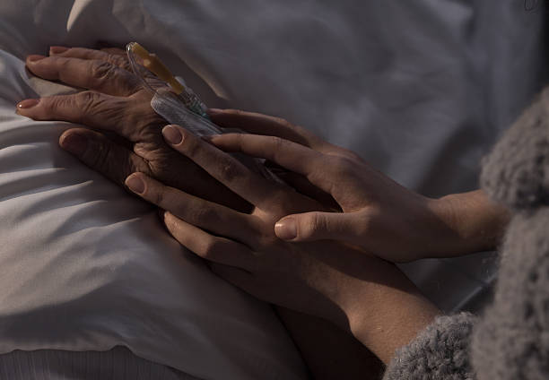istock Woman holding ill mother hand 501741590