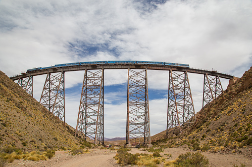 Photograph of a train driving over the Polvorilla viaduct in the Northwest of Argentina.