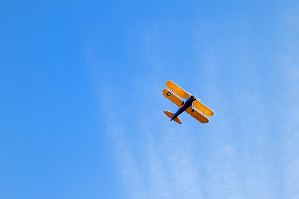 istock Biplane aircraft flying overhead in sky 501746524