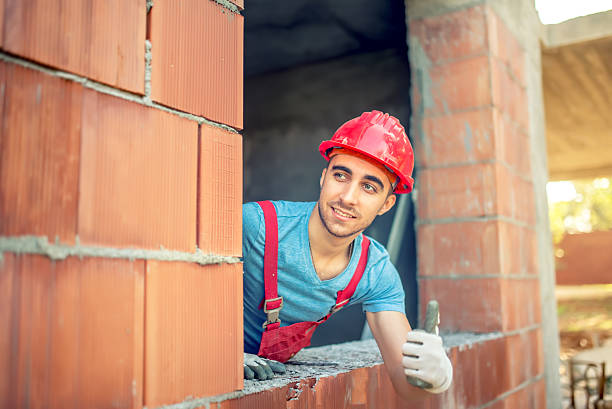 industrial worker showing ok hand sign on construction site industrial worker showing ok hand sign on construction site. Building engineer with quality control approving construction hand with a plaster spatula stock pictures, royalty-free photos & images
