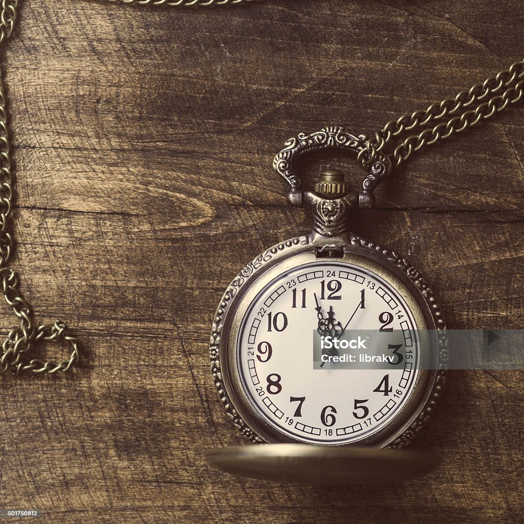 Photo  of old vintage pocket watch on rustic wood Photo  of old vintage pocket watch on rustic wood.  Retro filtered image 1950-1959 Stock Photo