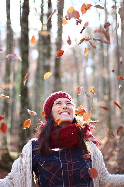 istock Young beautiful woman plays with beech leaves in the forest 501751162