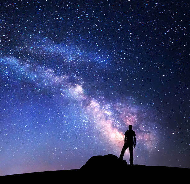 istock Milky Way. Night sky and silhouette of a man 501762536