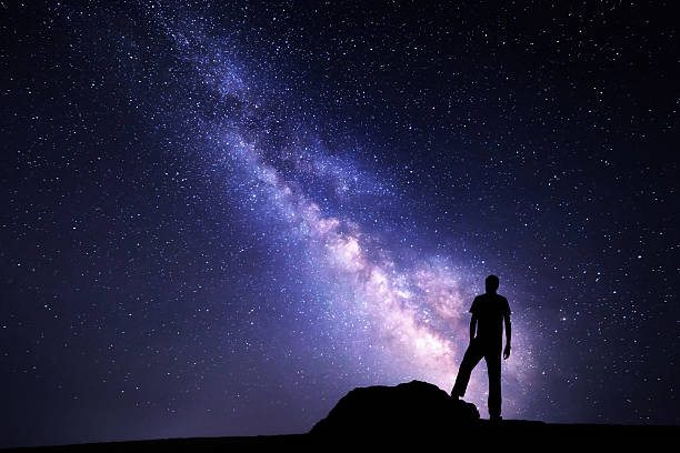 istock Milky Way. Night sky and silhouette of a man 501762616