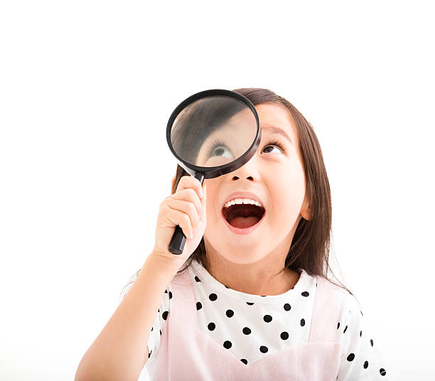 menina olhando através de uma lupa - searching child curiosity discovery imagens e fotografias de stock