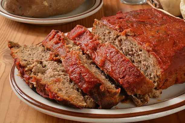 Meatloaf with tomato paste on a serving plate