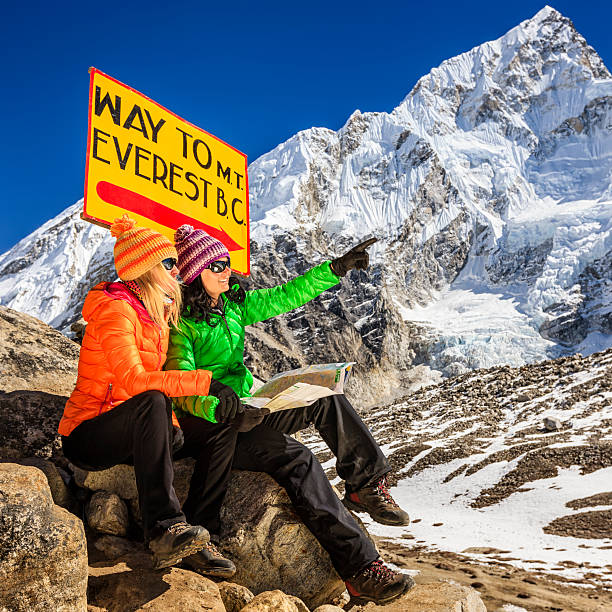 istock Young women studying map next to signpost, Nepali Himalaya 501771324
