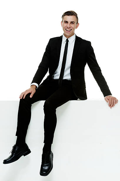 istock Smiling businessman sitting on box 501771468