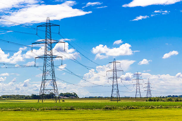 Row of Pylons Row of Pylons in the English countryside electricity pylon stock pictures, royalty-free photos & images