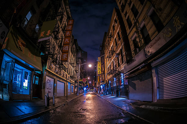 Abandoned Alley in Chinatown Dark, abandoned alley in New York City's Chinatown. run down neighborhood stock pictures, royalty-free photos & images