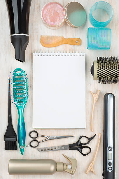 istock Professional hairdressing tools and accessories with blank notebook in center 501774594