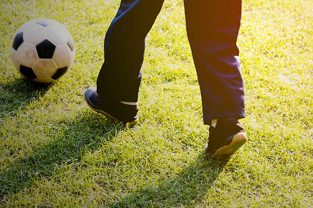 istock kid playing football 501775222
