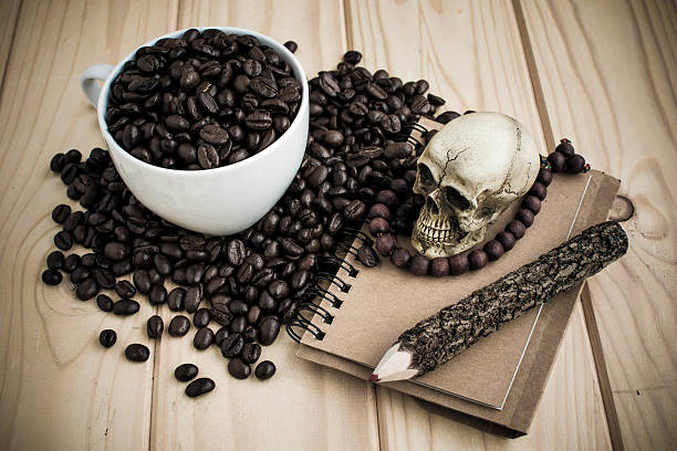 istock coffee cup with coffee beans and skull 501775298