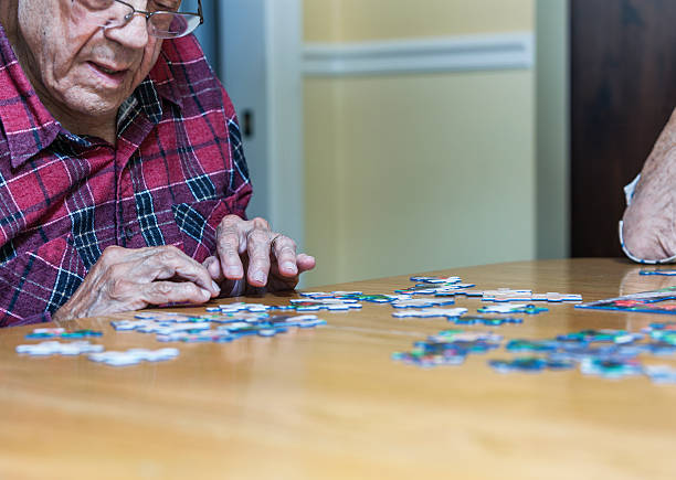 istock Senior Man And Woman Working Jigsaw Puzzle 501776353