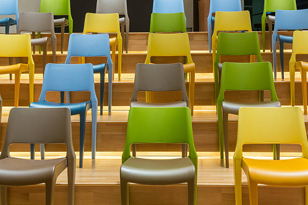 istock Colorful plastic chairs on wooden steps floor 501776546