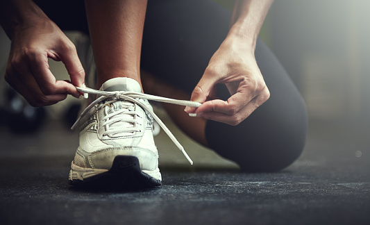 Cropped shot of a young woman tying her shoelaceshttp://195.154.178.81/DATA/i_collage/pu/shoots/806123.jpg