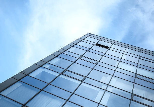 istock Modern office building wall made of glass with sky 501776869