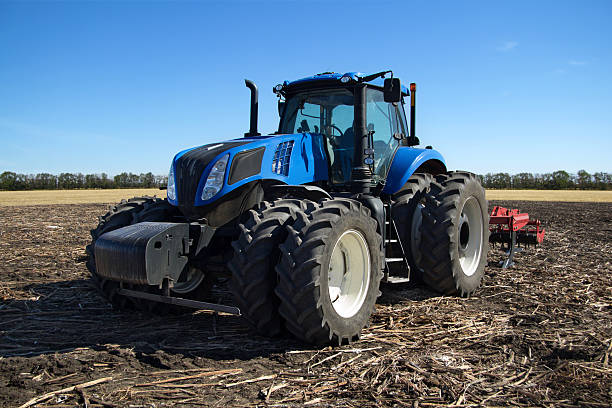 Blue tractor with plow stock photo