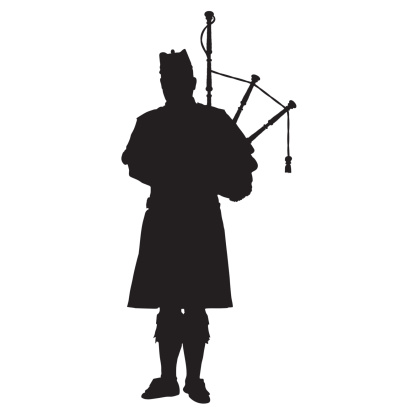 A black silhouette of a Scottish piper playing the bagpipes