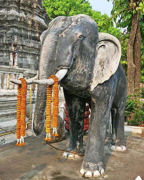 Old elephant statue in Buddhist temple stock photo