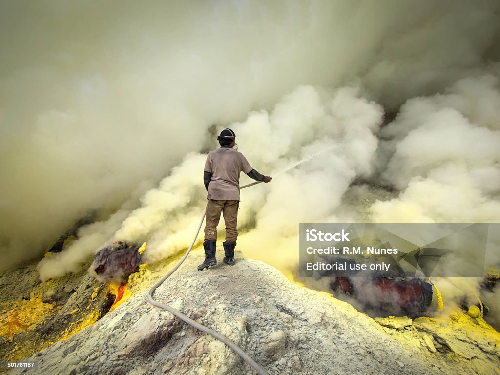 Mineiro de enxofre jogando água na Pipes at Kawah Ijen, Indonésia - Foto de stock de Asiático e indiano royalty-free