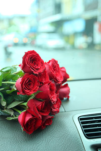 istock Red roses bouquet on car console. 501786948