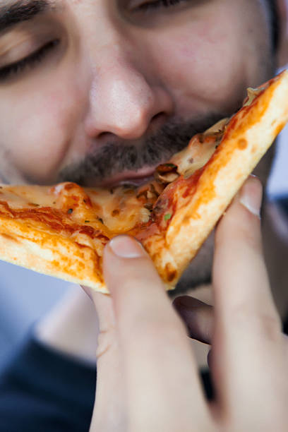 istock Hungry man enjoying and eating pizza 501788796