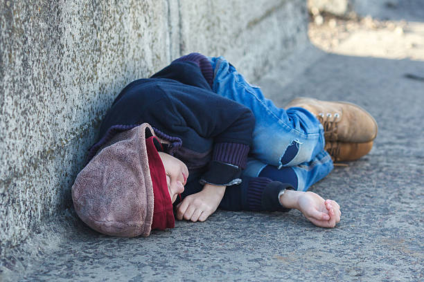 istock young homeless boy sleeping on the bridge 501789540