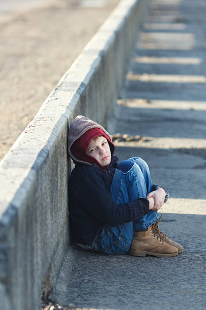 istock dramatic portrait of a little homeless boy 501789834