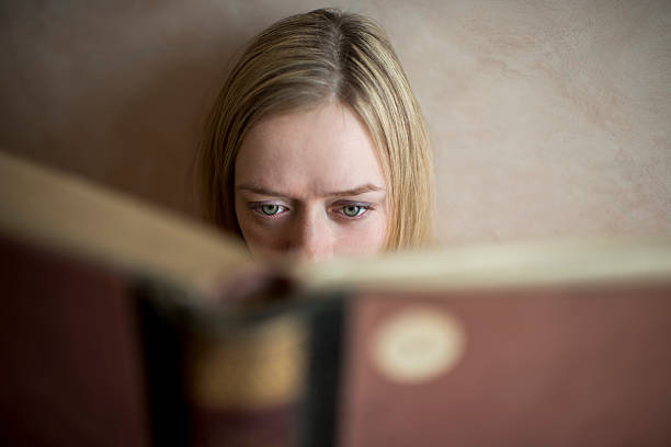 istock Close up of a woman reading a book. 501790480