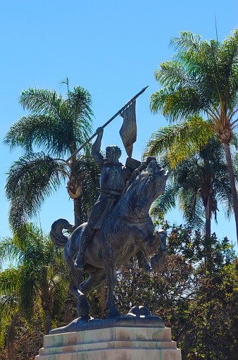 The statue of El Cid, Rodrigo DÃ­az de Vivar, a spanish medieval hero on a horse holding a spear and shield. The sculpture was a gift by Anna Hyatt in Balboa Park, San Diego, California in plaza de Panama