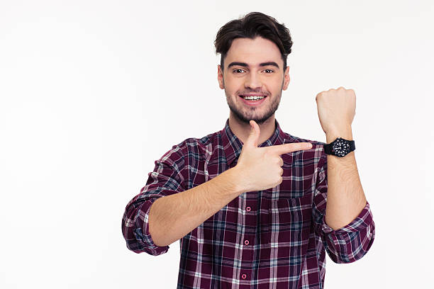 istock Smiling man pointing finger on wrist watch 501791506