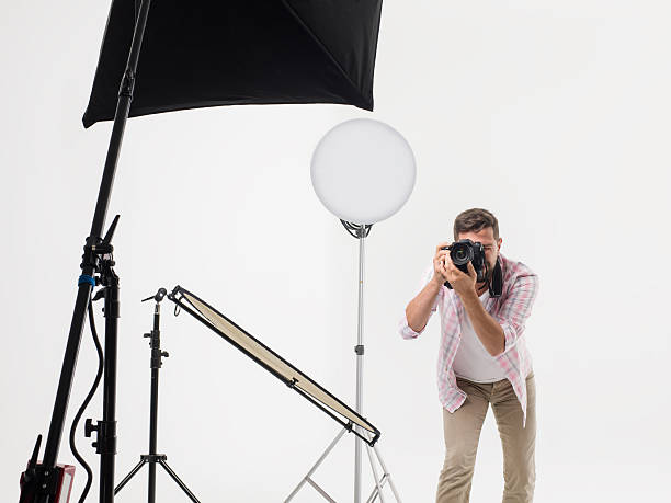 istock Photographer man photo shooting in studio 501792928