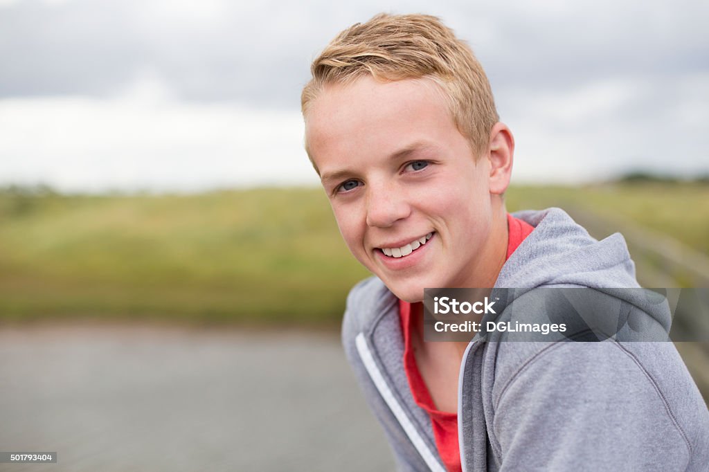 Happy Outdoor Portrait Portrait of a teenage boy smiling at the camera. He is outdoors and wearing casual clothing. Teenage Boys Stock Photo