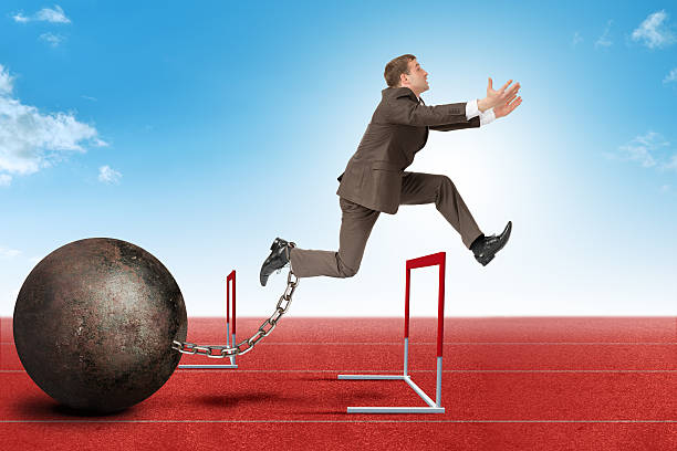 istock Businessman jumping over barrier 501793600