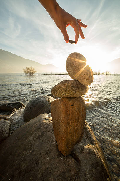 istock Woman builds zen-like sculpture 501793612