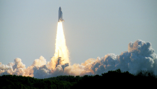 A space shuttle blasts off the launching pad at Cape Canaveral, Fla.
