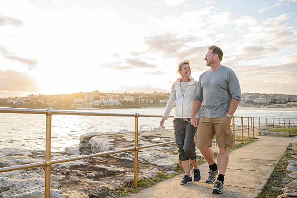 istock Mature couple walking on boardwalk at sunset, Bondi Beach 501793822