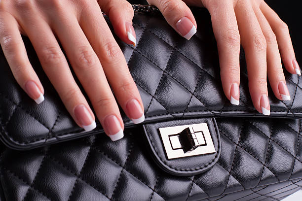 istock Beautiful french manicure with leather bag. 501794044