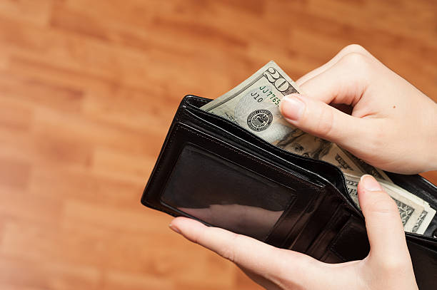 istock Human hand takes money bills from wallet closeup 501794953