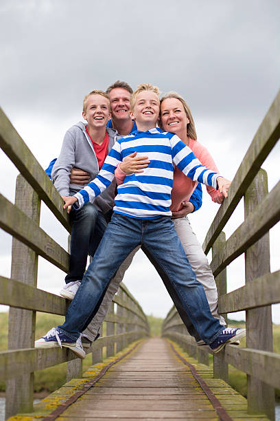 Family father, mother, son and daughter celebrate Christmas together, happy, stylish