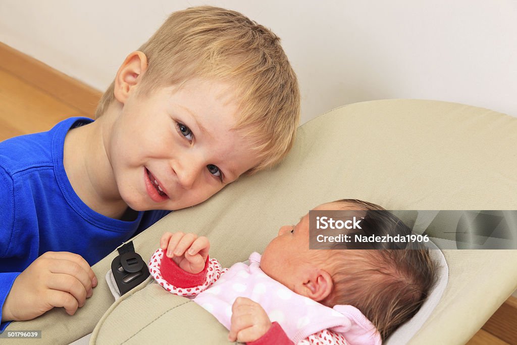 Brother enjoying time together with newborn sister, family concept Bouncer - Bowled Ball Stock Photo
