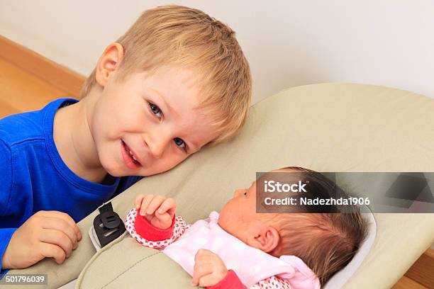 Brother Enjoying Time Together With Newborn Sister Family Concept Stock Photo - Download Image Now