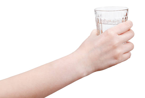 istock hand holds mineral water in glass isolated 501796807