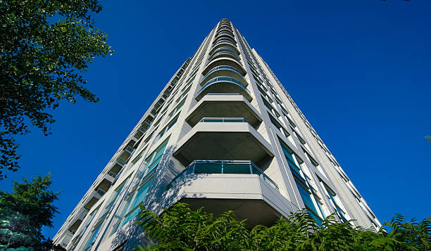 istock Condominium - rising tower into blue summer sky. 501797430