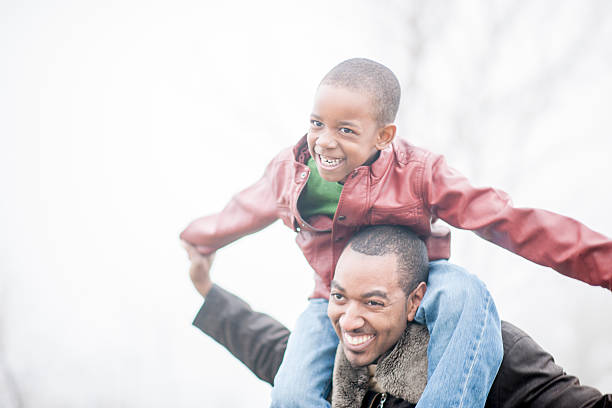 istock Little Boy Riding on His Dad's Shoulders 501798072