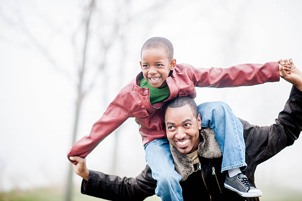 Son Riding on His Father's Shoulders