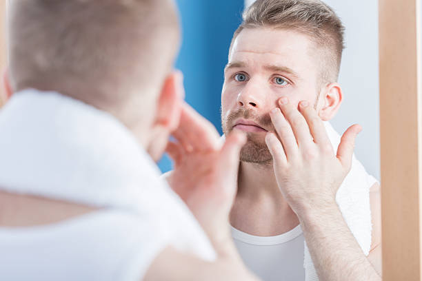 istock Male narcissus examining complexion 501798776